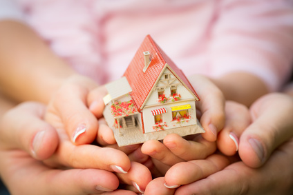 Picture of family holding house